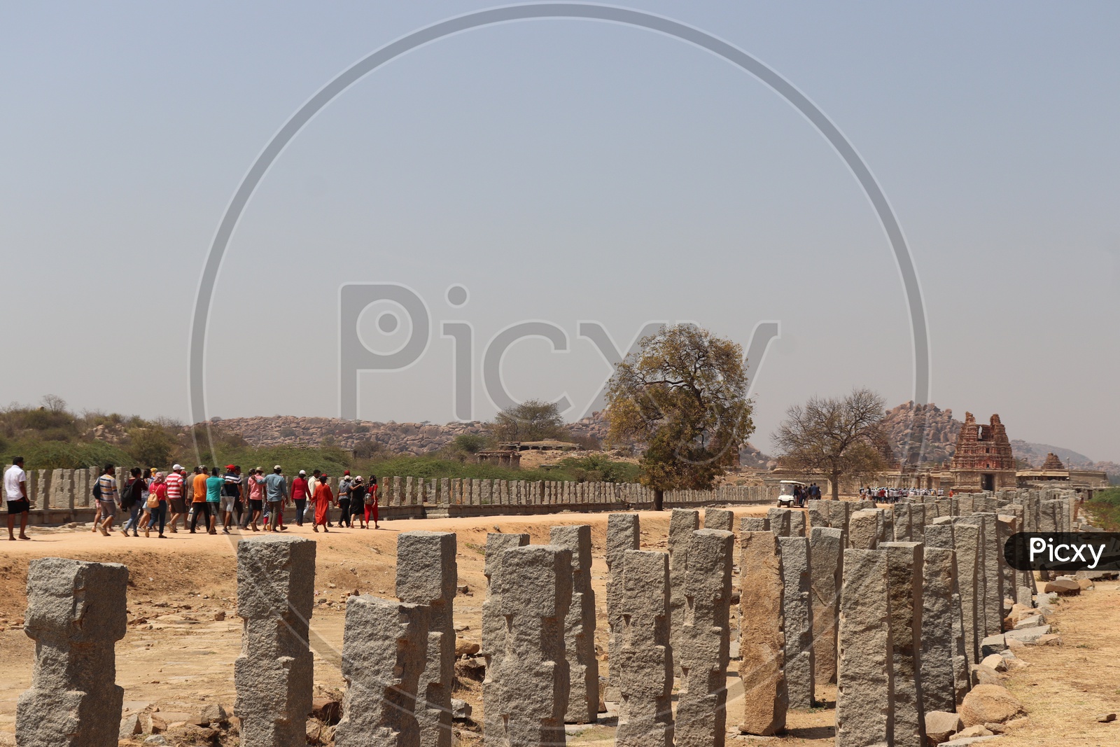 Tourists Walking Towards Ancient Temples in Hampi