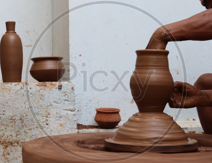 Image of A Professional Potter Sculpting The Clay Pots With Potter