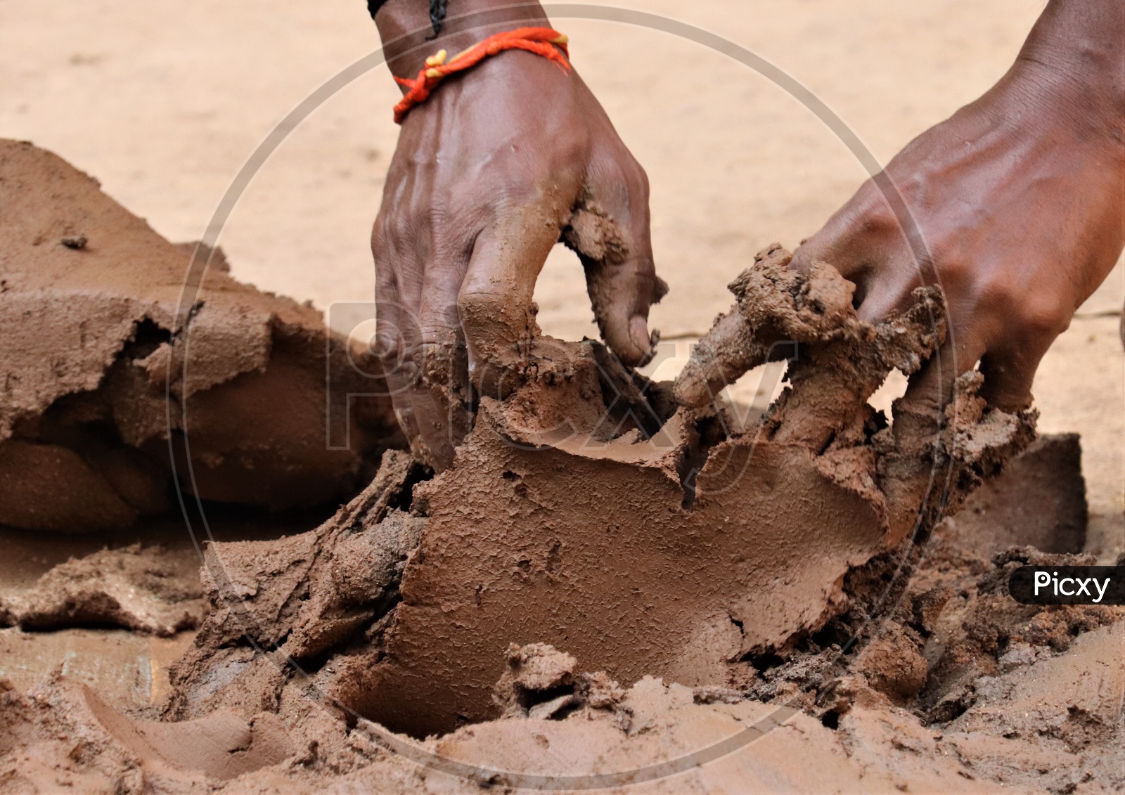 image-of-a-professional-potter-kneading-regur-soil-with-hands-closeup