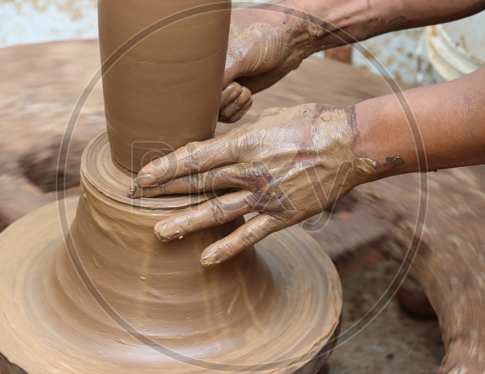 A Professional Potter Sculpting The Clay Pots With Potter Wheel  or Pottery