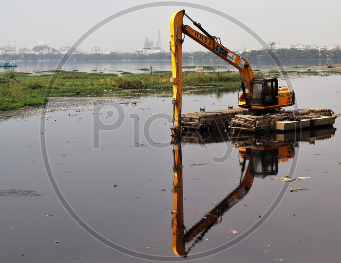 A JCB Working On The Hussain Sagar lake At Necklace