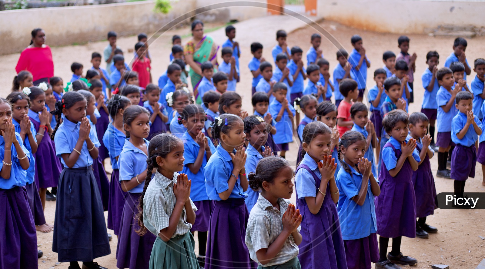 Govt school students performing morning prayer at school.