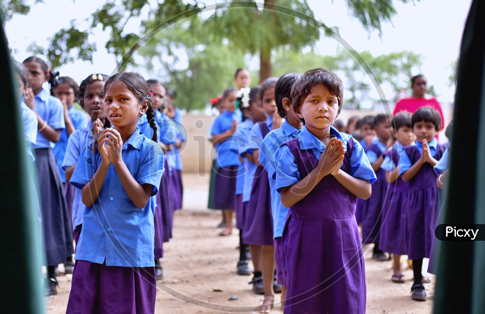 Govt school students performing morning prayer at school.