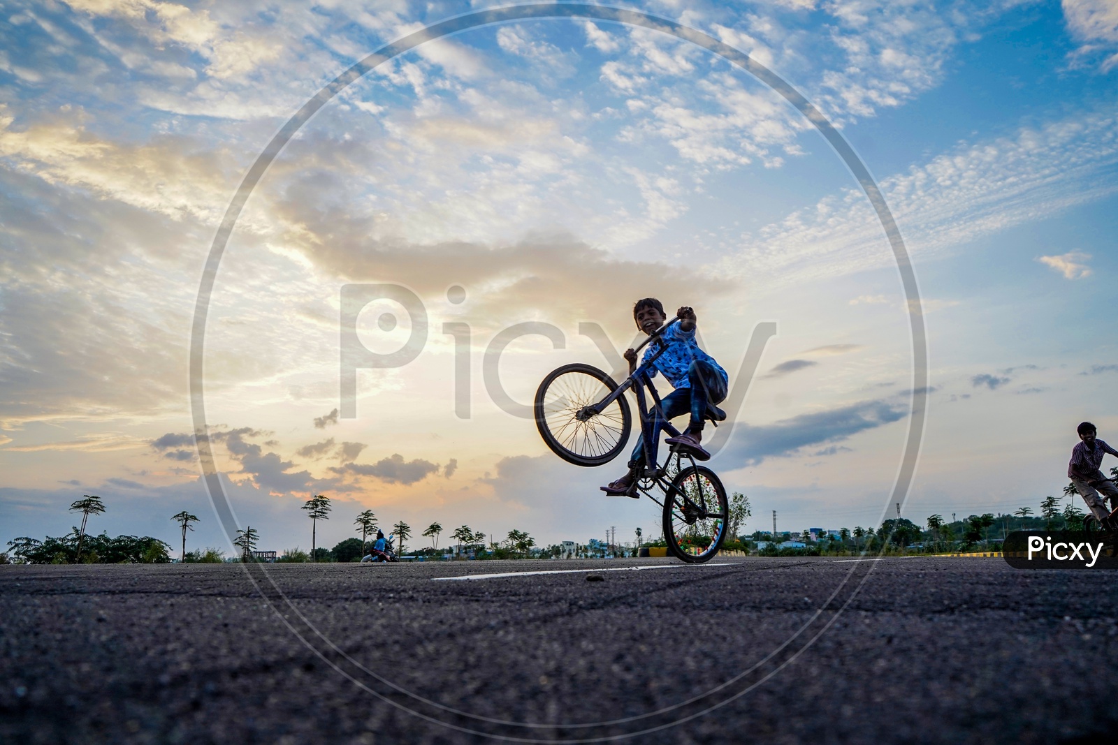 Happy Or Joyful Indian Young Boys Performing Bicycle Stunts