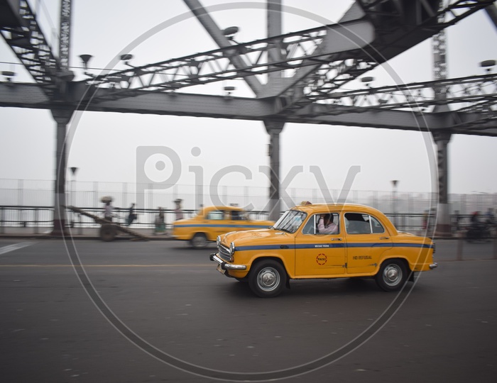 Yellow taxi on Howrah bridge