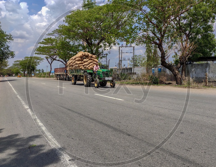 tractor loaded with rice husk is transported