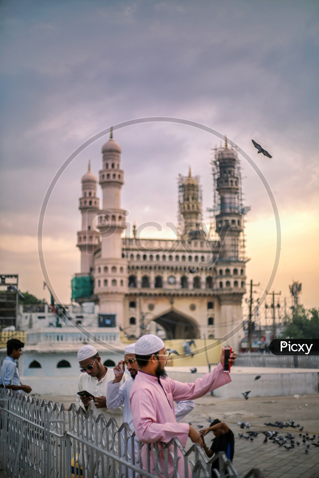 A Muslim man Taking Selfie In Mecca Masjidh  With Charminar in Background