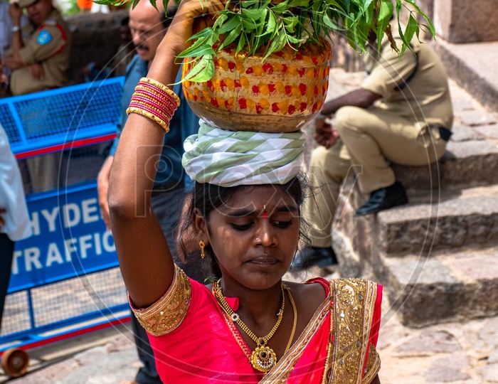 Woman carrying Bonam at Golconda bonalu celebrations.