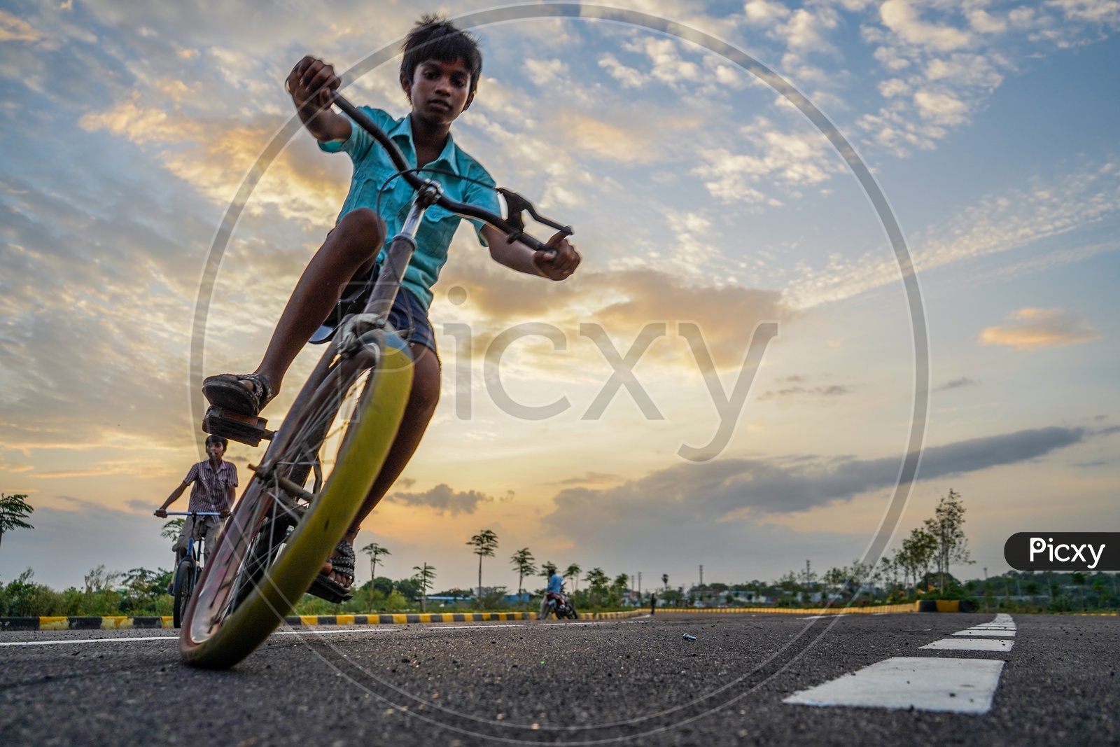Happy Or Joyful Indian Young Boys Performing Bicycle Stunts