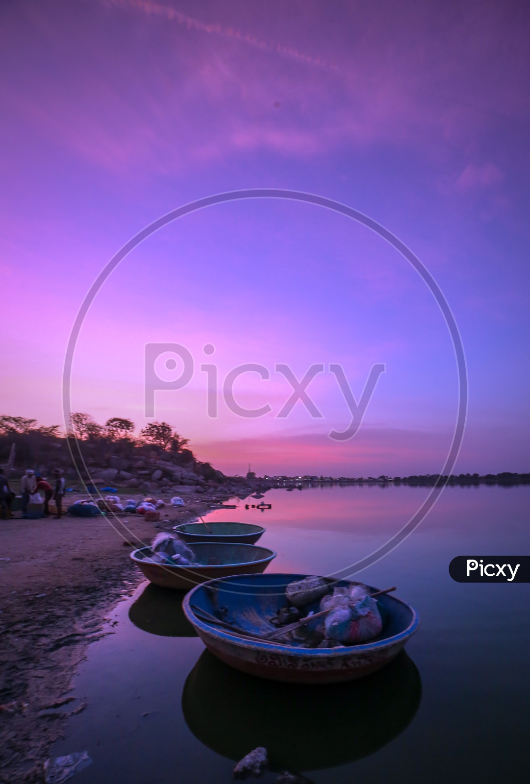 Fishing Coracle Boats At a Lake With Blue hour Sky In Background