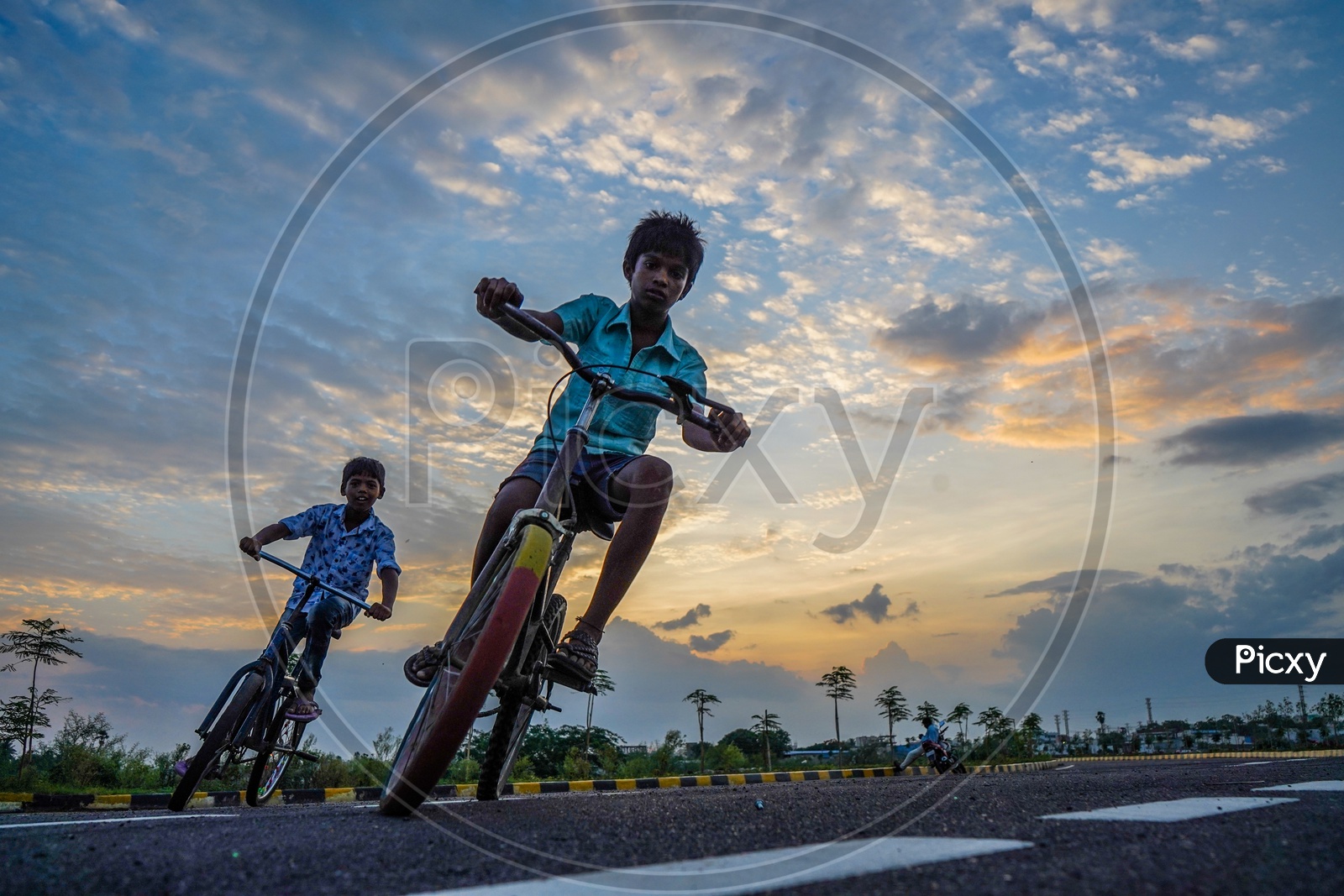 Happy Or Joyful Indian Young Boys Performing Bicycle Stunts