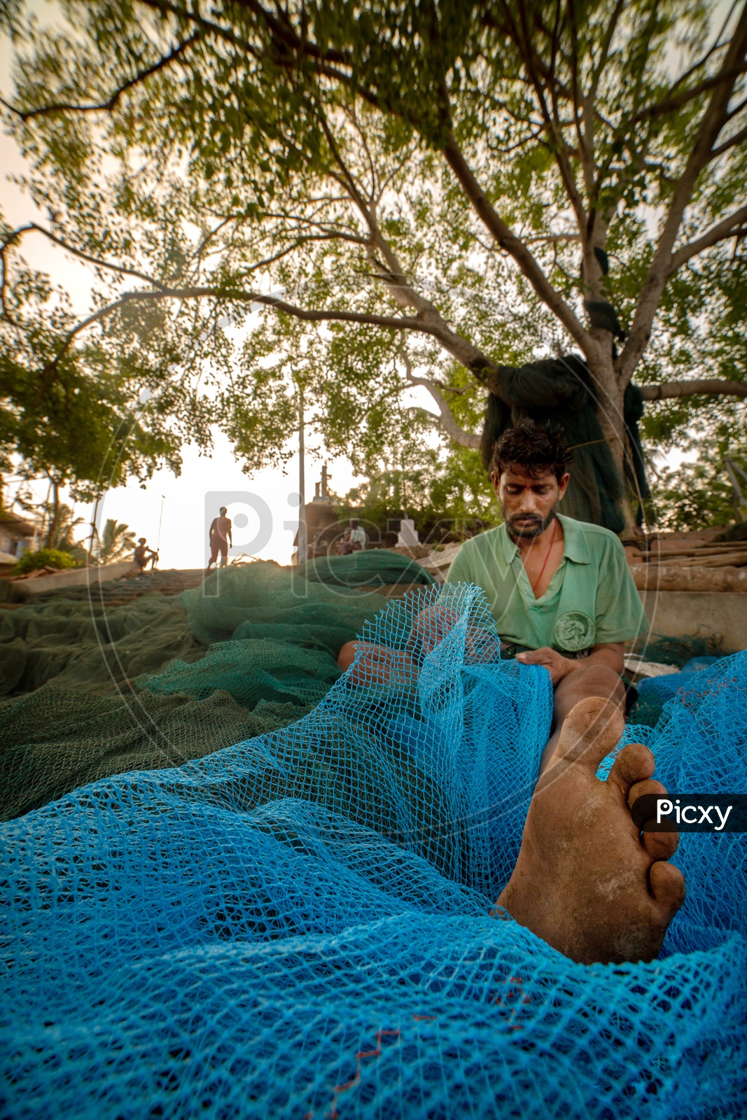 A Fisherman Renovating His Fishing Net