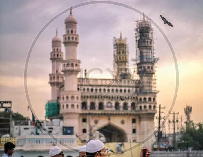 A Muslim man Taking Selfie In Mecca Masjidh  With Charminar in Background