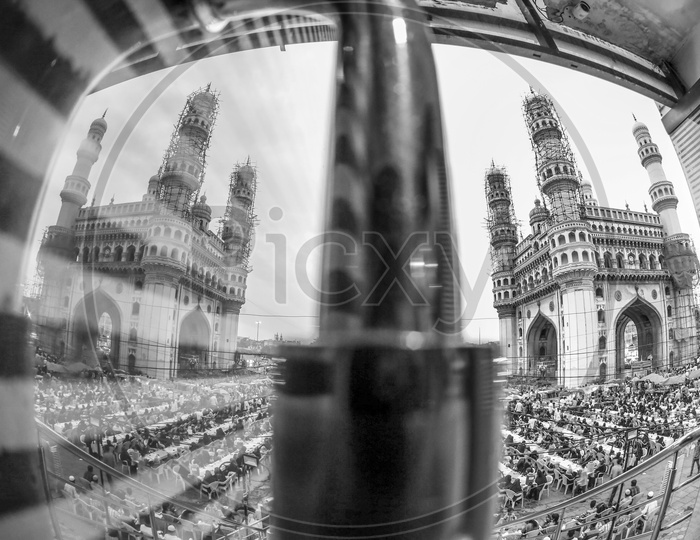A Composition Shot Of Charminar And Its Reflection On the Glass Door