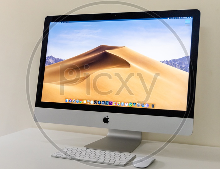 Computer or Desktop  Along With  Keyboard  At Office Desk  With a  Wallpaper Display on Screen On a White Desk Background