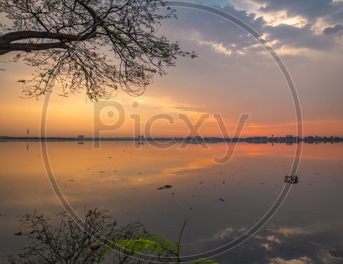 A View Of Lake With  Sunset Sky In Background