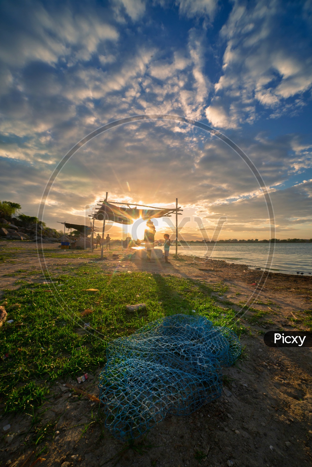 Fishing Nets At The  Bank Of a Lake With Blue Sky And Cotton clouds In Sky As a Background