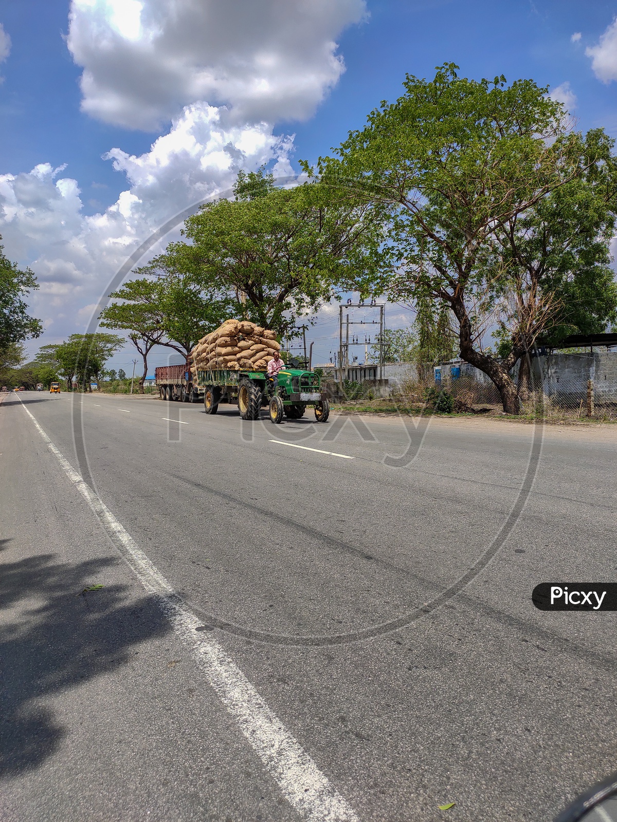 tractor loaded with rice husk is transported