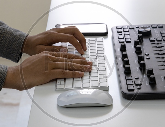 Closeup Of  Man Hands or Fingers  Working On Computer Keyboard at Office Desk