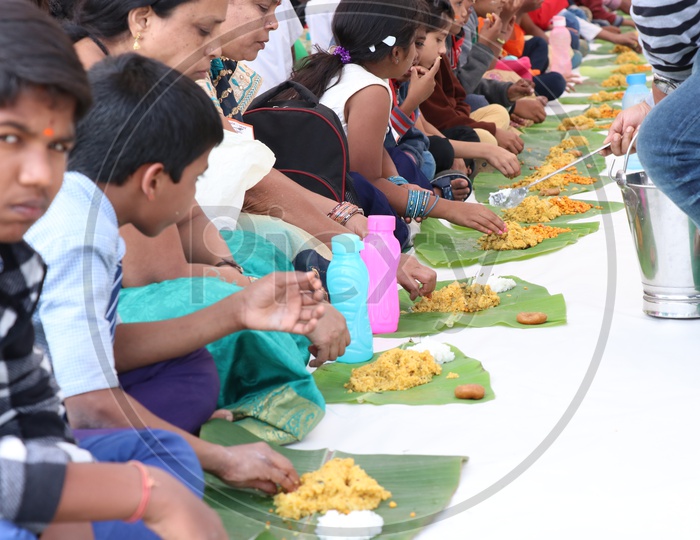 School Children Having Lunch or Enjoying Feast Outdoor Serving In Banana Leaf