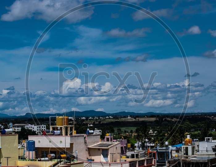 City Scape Of Halebeedu  Town With Cotton Clouds And Blue Sky
