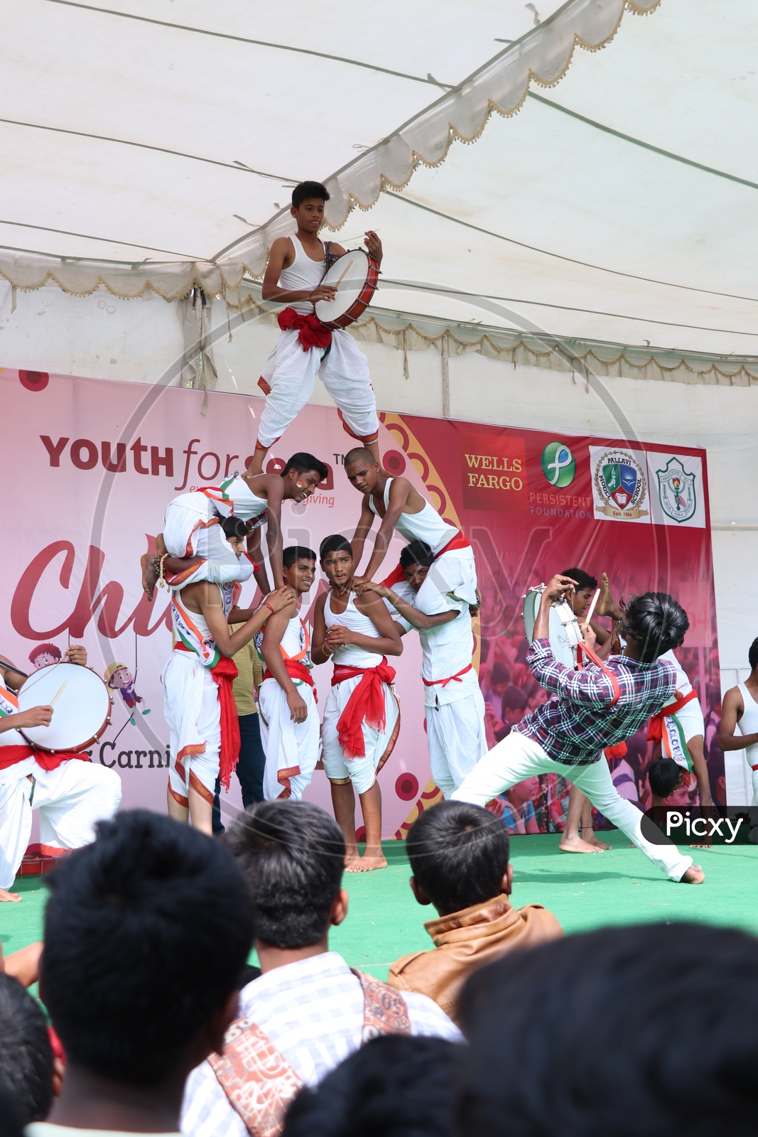 Indian Young  School Children or Students  Performing With Traditional Folk Drums On Stage In an Event