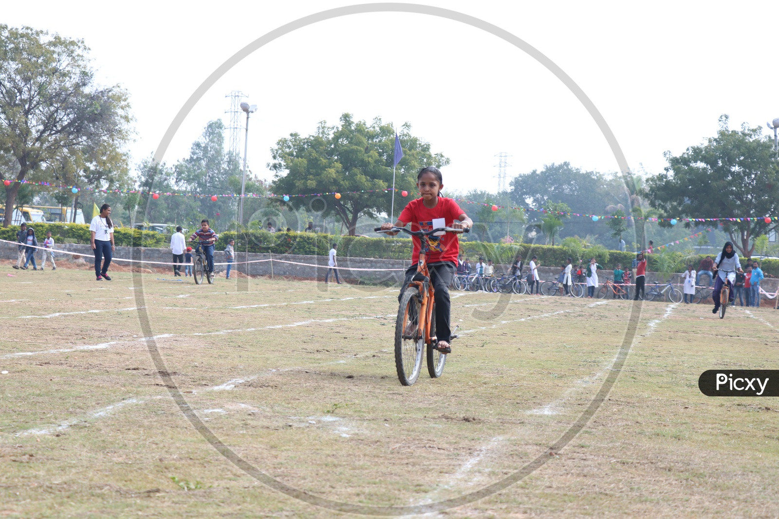 Indian You g School Girl Participating In a Cycle Race Competition In a School Sports Day Or Athletic Meet