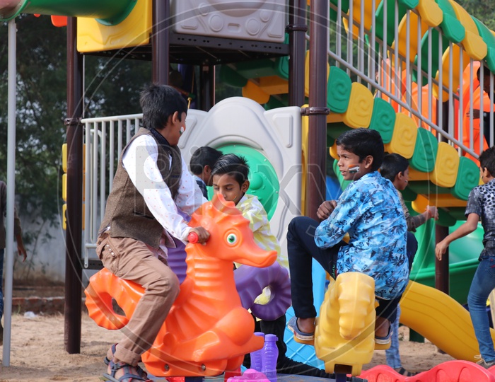 Children Playing With   Equipment in  Playing area  in a Park