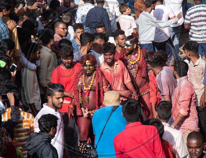 Pothuraju  Being Beating  and Dancing along The Crowd With  Red Coloured Lashing  Whips And With Neem  Leafs  at Bonalu Festival