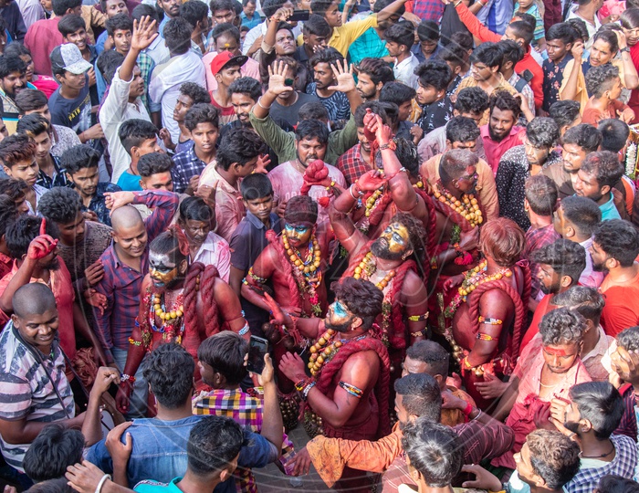 Pothuraju  Being Beating  And Dancing Along The Crowd With  Red Coloured Lashing  Whips And With Neem  Leafs  at Bonalu Festival