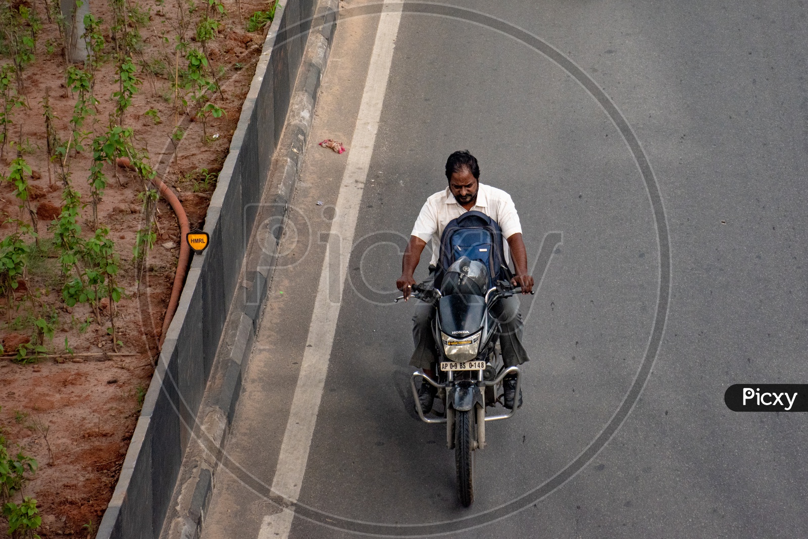 Riding a motor bike without wearing a helmet.