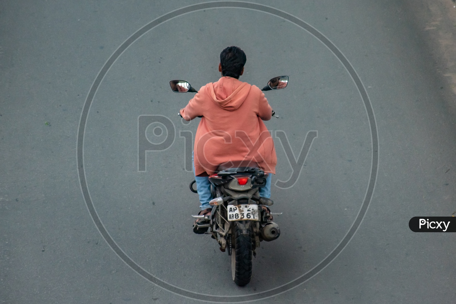 Riding a motor bike with irregular number plate.