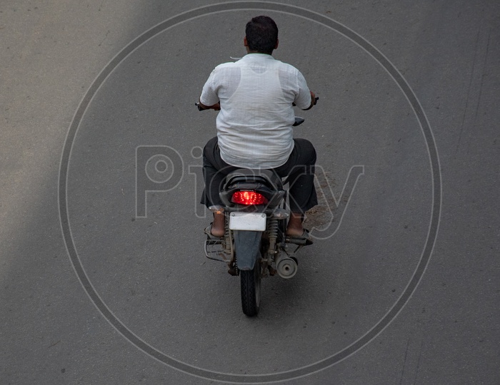 Riding a motor bike without proper number plate.