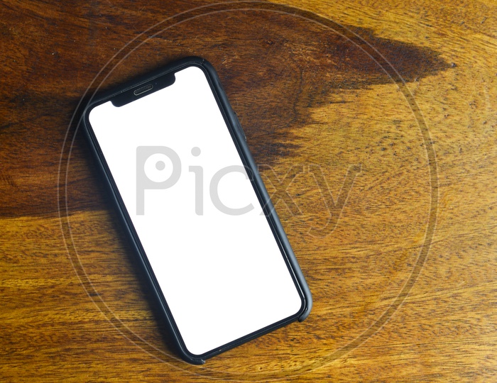 Smartphone or Mobile  With Empty Space Or White Space For Advertising Purpose  on an Wooden Background