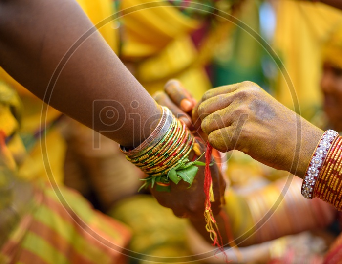 Kankanam Or  Hand Bands Being Tie To Wrists During Bonalu Festival