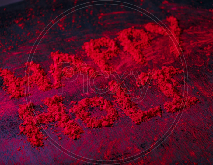 Happy  Holi  Wishes Written With Holi Colours on an Black Background