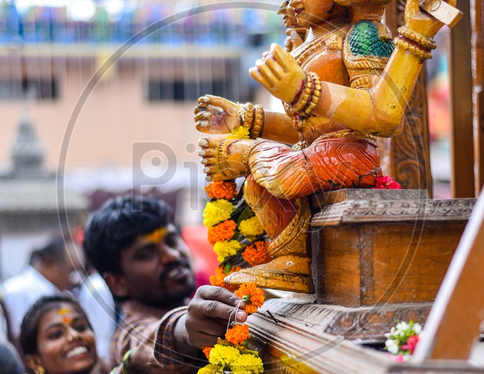 Devotees Offering Garlands To Temple Procession Wooden Chariot At Bonalu Festival