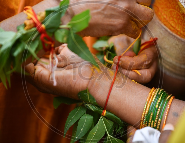 Kankanam Or  Hand Bands Being Tie To Wrists During Bonalu Festival