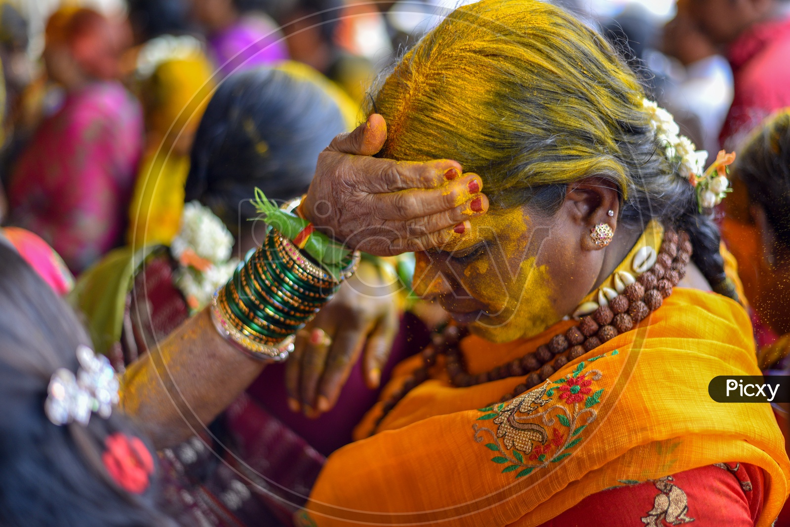 Woman Applying Yellow Colour  Turmeric  To Their Foreheads At Bonalu Festival Celebrations