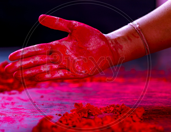 Holi Colours Filled Hand Closeup On an Black Background