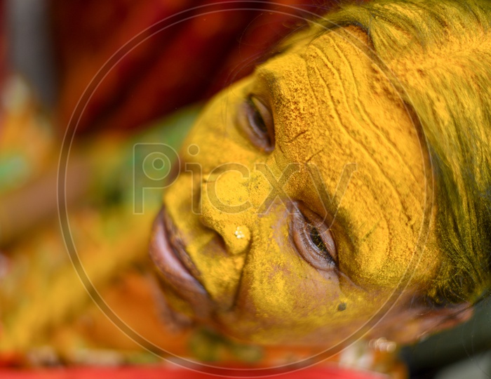 Portrait Of a Woman Applying Yellow Colour  Turmeric  To Their Foreheads At Bonalu Festival Celebrations