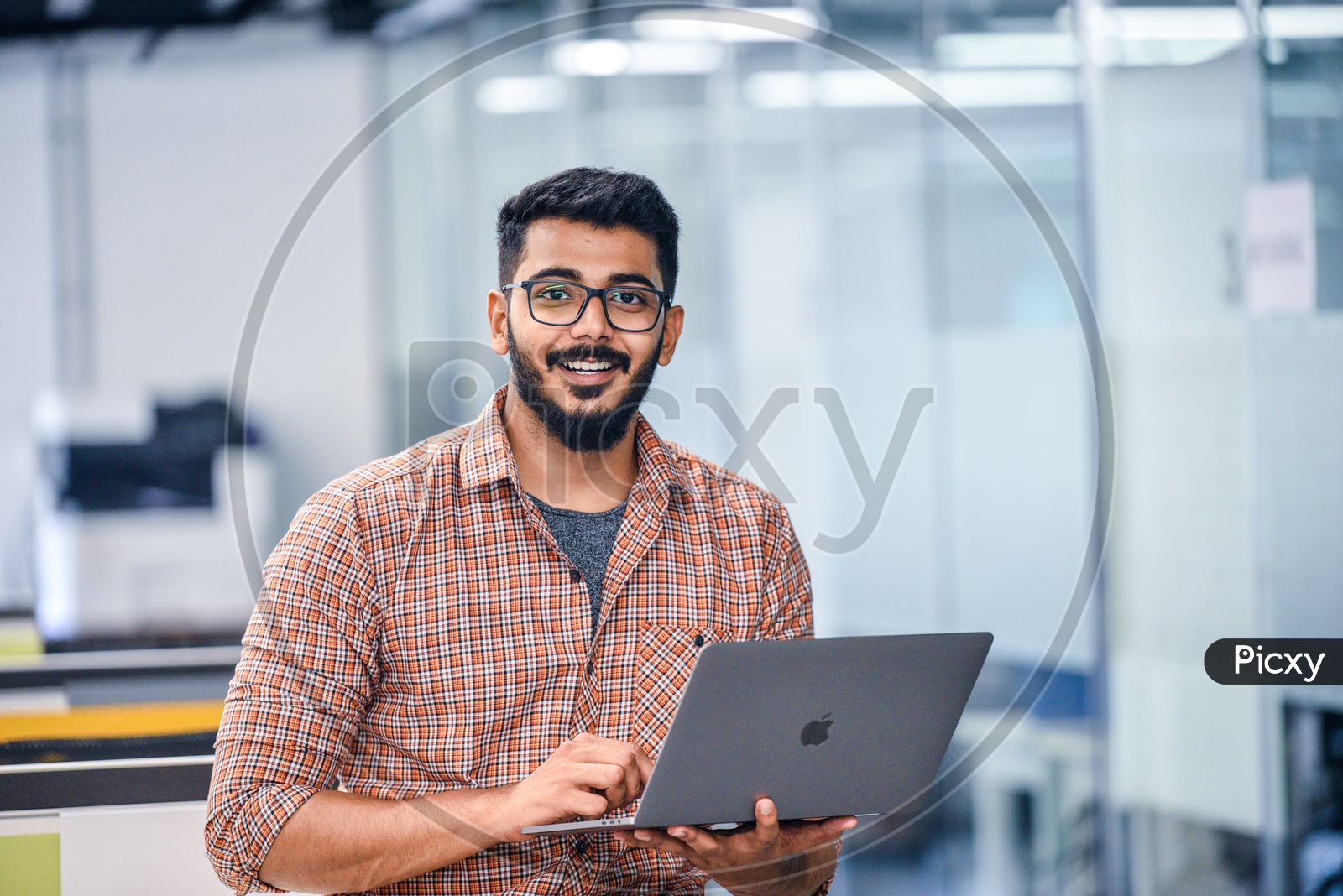 Indian IT Professional Employee Worker Young Man Student  Happily Smiling Using Laptop in Office Working Space