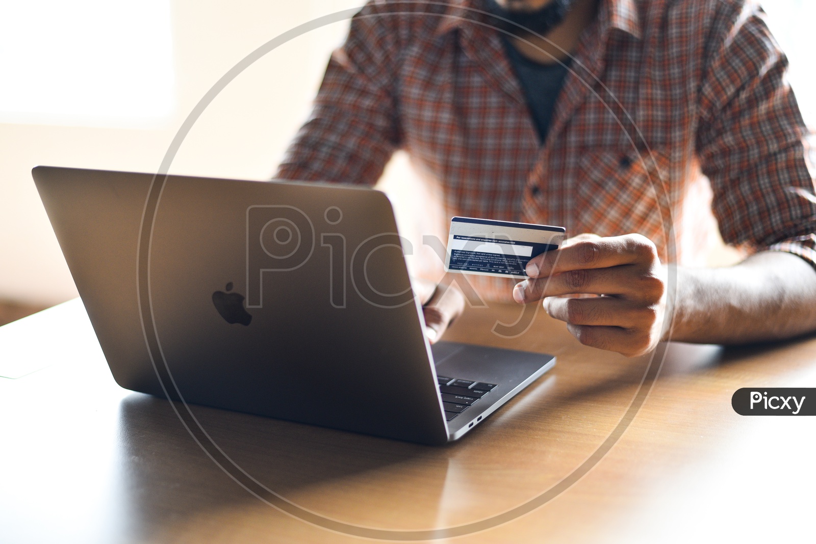 Online Payments Or Online Shopping  A Young Man Using Debit or Credit Card For Online Transaction or Payments in Laptop