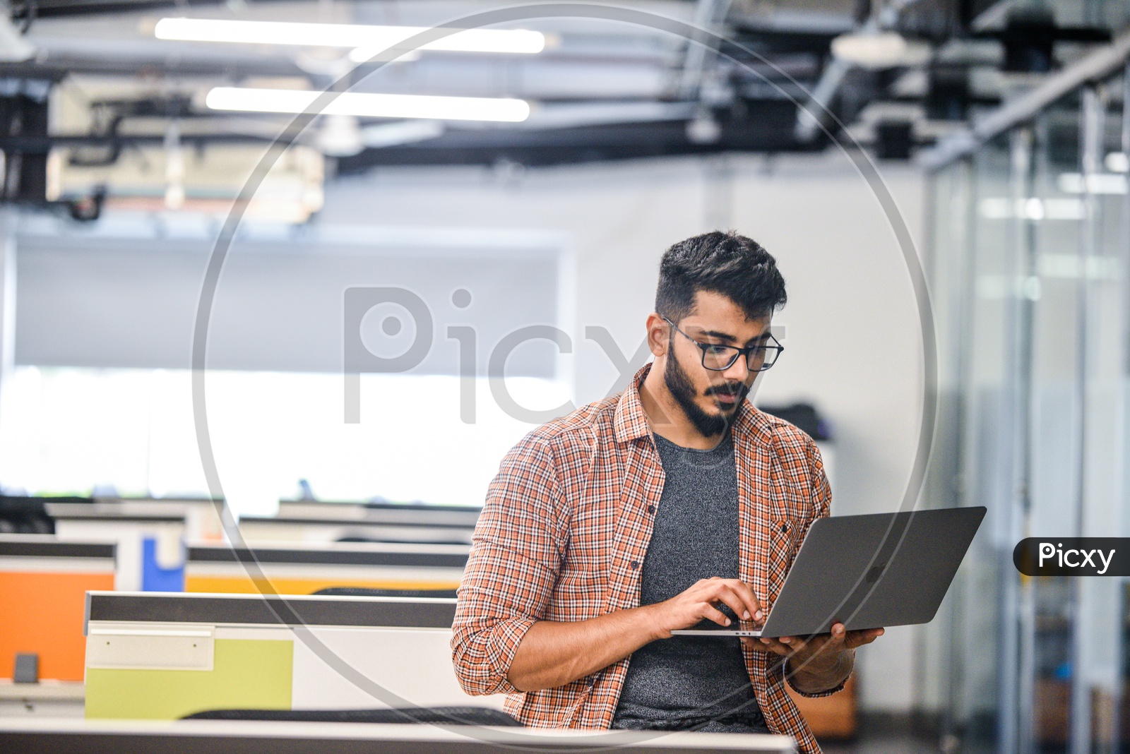 Young Man Or Indian Man  Focused Serious Working On Laptop In Office Work Space