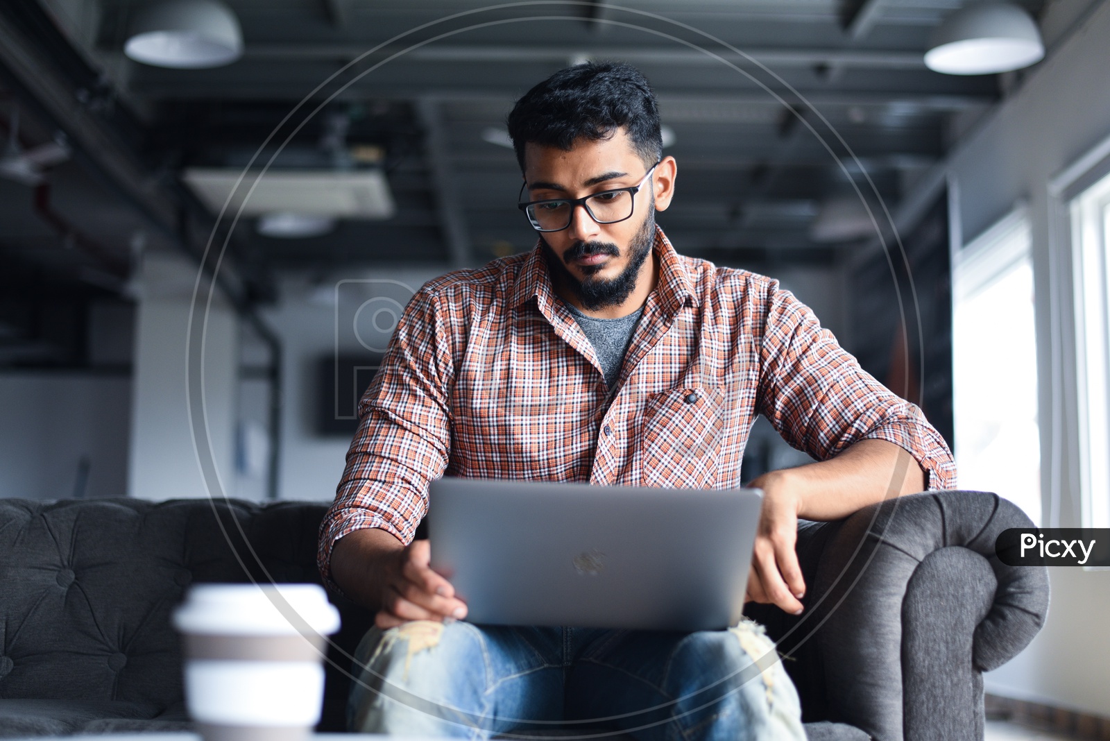 Image of Focused Serious Working Young Man Or Indian Man On Laptop in a ...