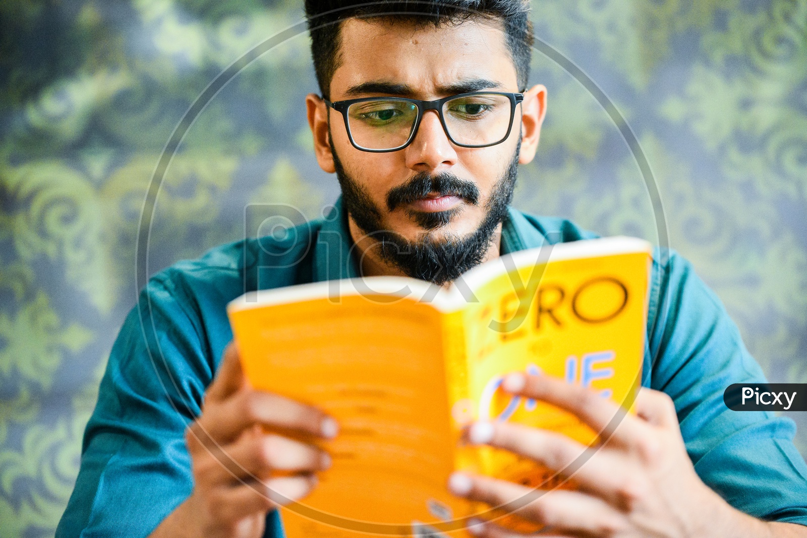 Young Man Or Student With Beard  Reading Book Or Novel