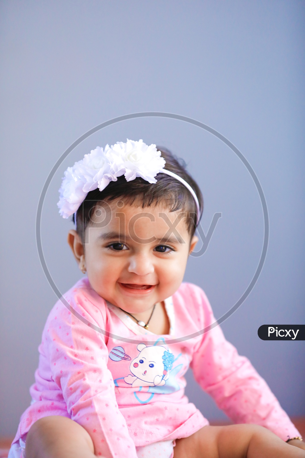 Cute Indian Baby Girl With Smiling Face On an Isolated White Background
