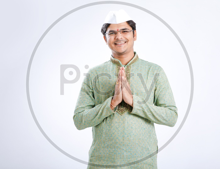 Indian Man Wearing Traditional Dress  With Namaste Gesture and Maharashtra  Cap or Marathi Cap on an Isolated White Background