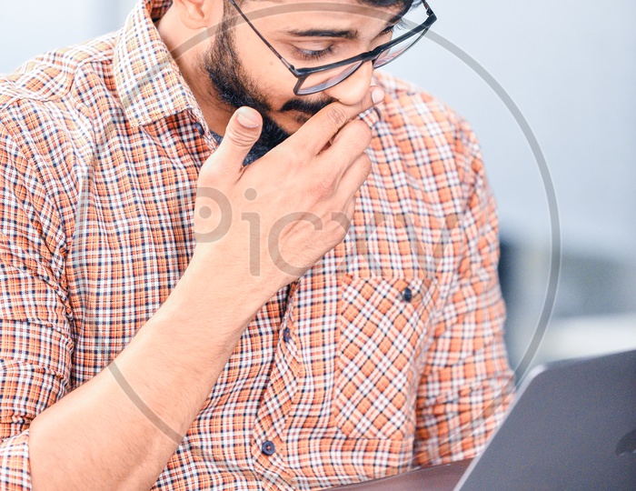 Focused Serious Working Young Man Or Indian Man On Laptop In Office Work Space