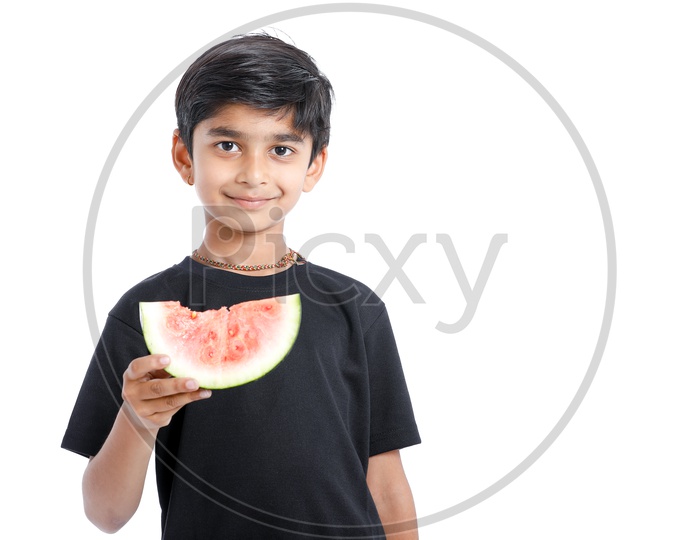 Indian Cute Boy  or  Asian Boy or kid Enjoy Eating  Watermelon With an Expression On an Isolated White Background